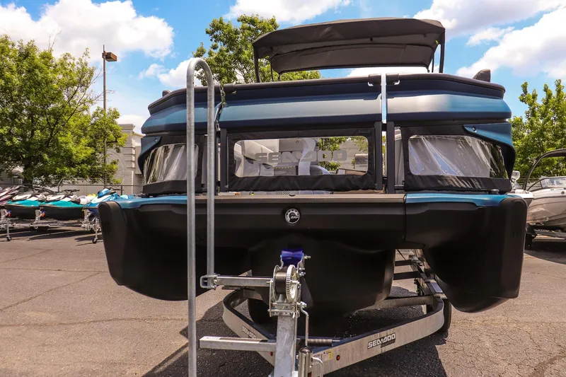 Slide: The Image of 2026 Sea-Doo Switch Cruise 21 pontoon boat on trailer, parked outdoors. - 8