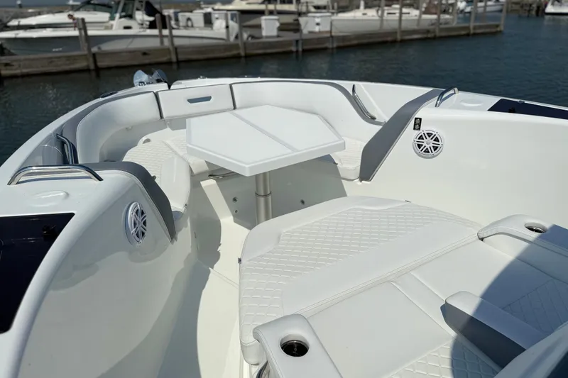 Slide: The Image of 2026 Wellcraft 38 T-Top boat interior with seating and table, docked at marina. - 14
