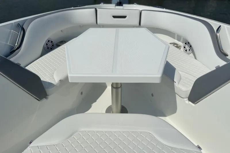 Slide: The Image of 2026 Wellcraft 38 T-Top boat interior with white seating and table. - 16