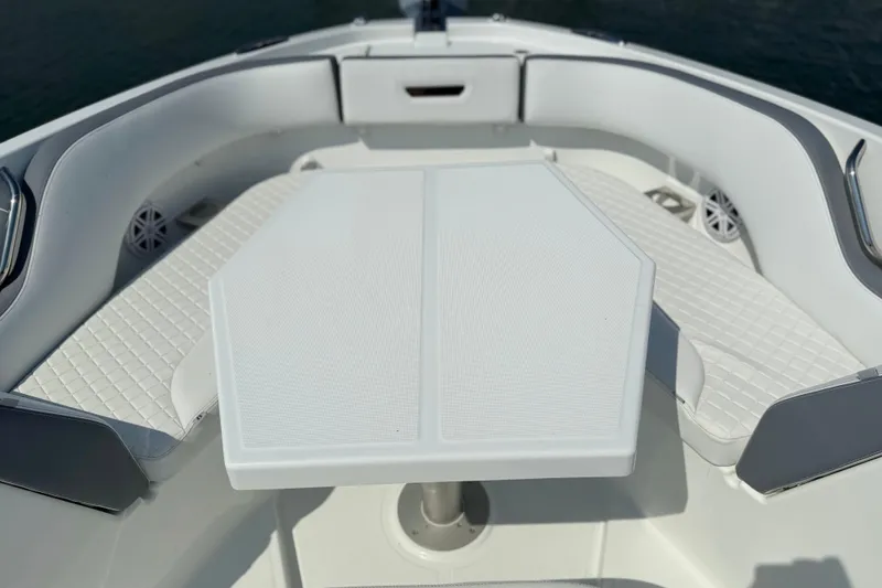 Slide: The Image of 2026 Wellcraft 38 T-Top boat interior with white seating and table. - 17