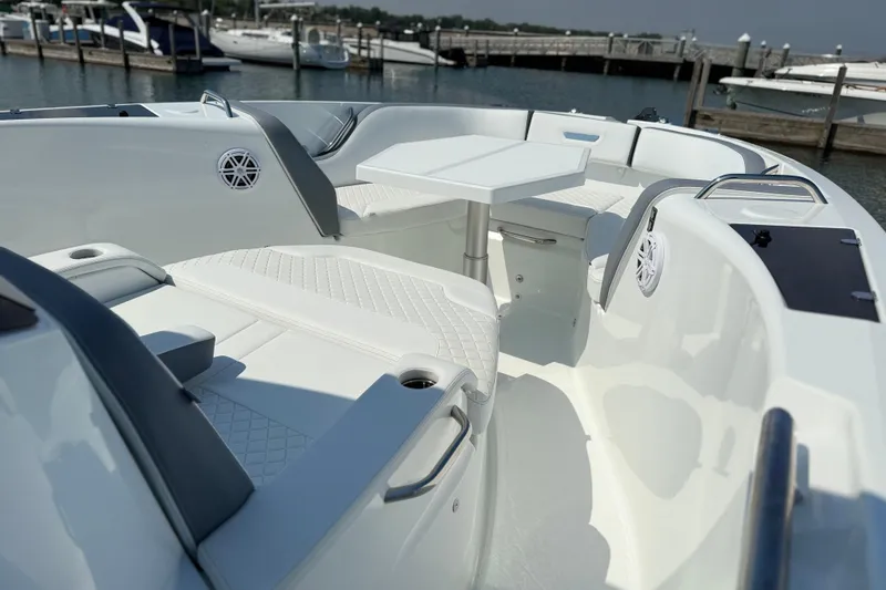 Slide: The Image of 2026 Wellcraft 38 T-Top boat interior with seating and table, docked at marina. - 18