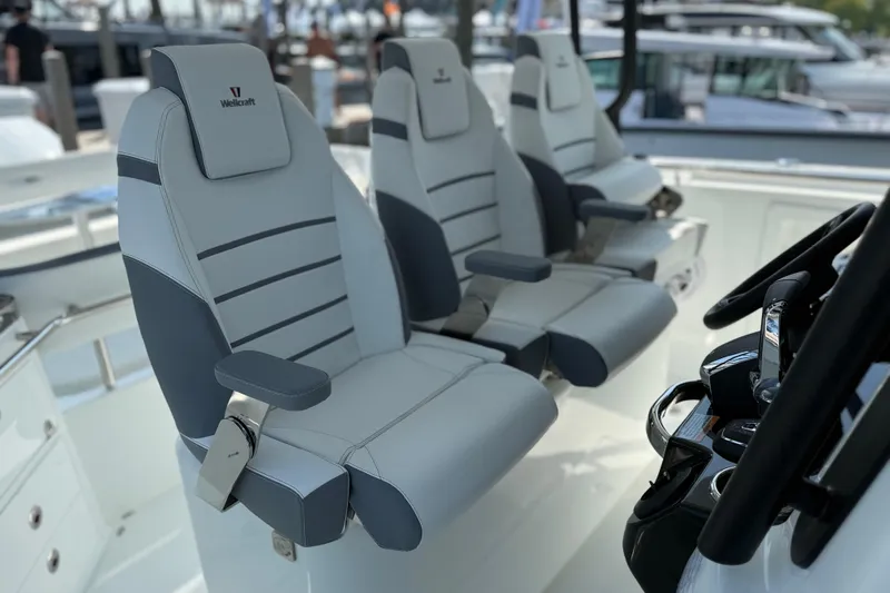 Slide: The Image of 2026 Wellcraft 38 T-Top boat interior with sleek, modern seating and steering console. - 20