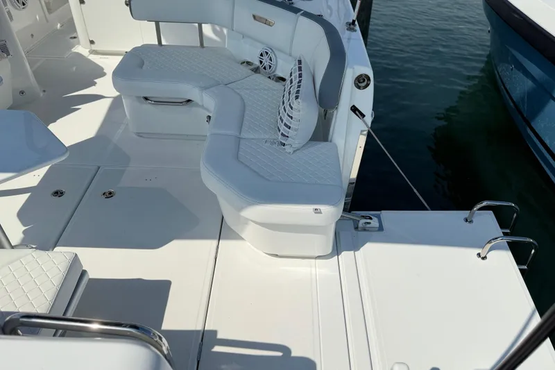 Slide: The Image of Luxurious seating on 2026 Wellcraft 38 T-Top boat, featuring white upholstery and modern design. - 24