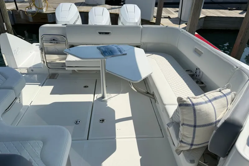 Slide: The Image of Luxurious seating area on 2026 Wellcraft 38 T-Top boat with table and cushions. - 27