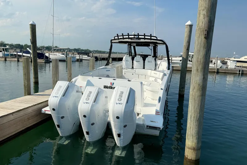 Slide: The Image of 2026 Wellcraft 38 T-Top boat docked with powerful outboard engines. - 31