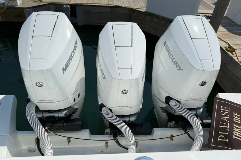Slide: The Image of Triple Mercury Verado engines on a 2026 Wellcraft 38 T-Top boat at dock. - 33