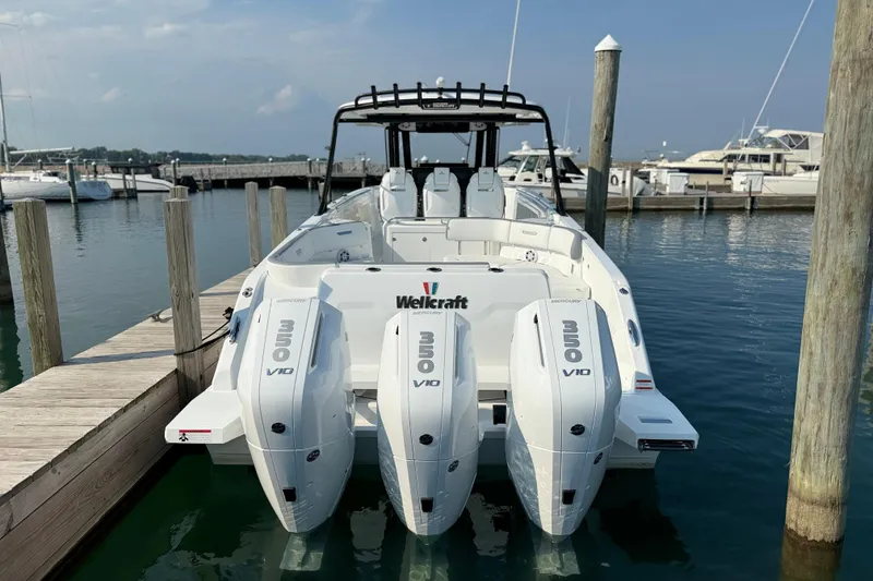 Slide: The Image of 2026 Wellcraft 38 T-Top boat docked, featuring triple Mercury 350 V10 engines. - 37