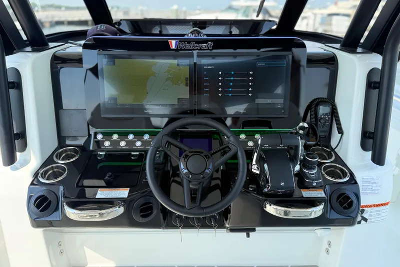 Slide: The Image of Helm of 2026 Wellcraft 38 T-Top boat with advanced navigation system and controls. - 4