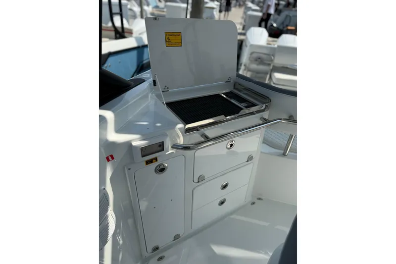 Slide: The Image of Outdoor grill station on 2026 Wellcraft 38 T-Top boat, featuring storage compartments. - 7