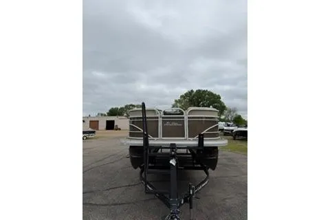 Slide: The Image of 2022 SUNTRACKER Party Barge 22 pontoon boat on trailer, parked outdoors. - 4