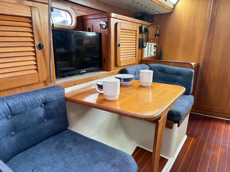 Slide: The Image of Interior of a 2000 Catalina 36 MkII yacht with wooden furniture and blue upholstery. - 16