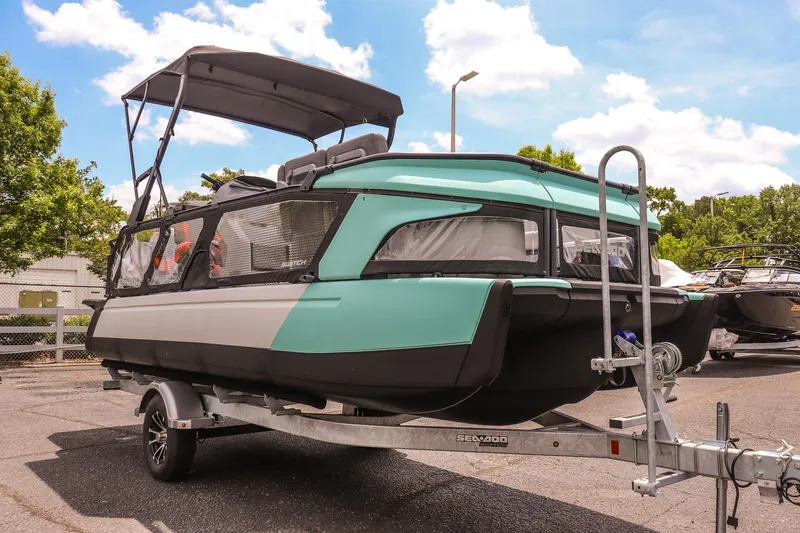 The Image of 2026 Sea-Doo Switch Cruise 21 on trailer, parked outdoors under a clear sky. - 1