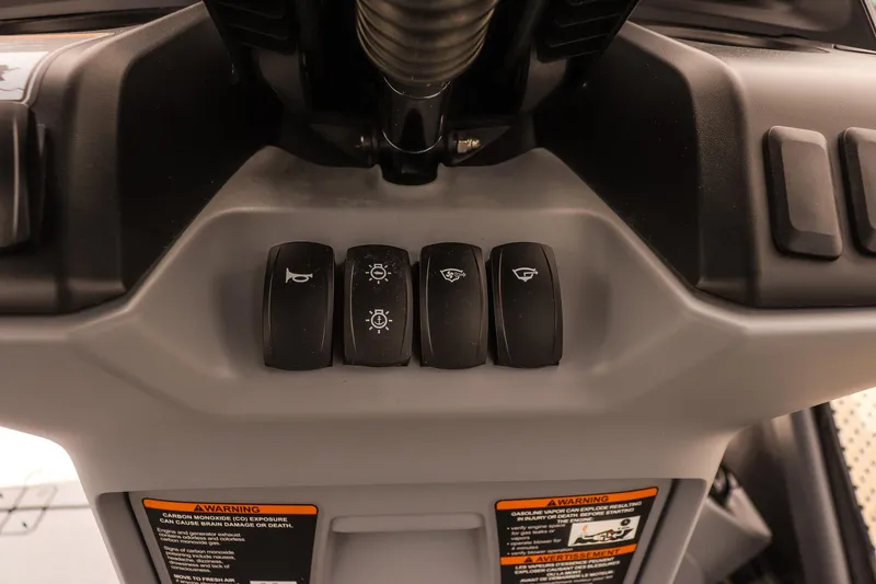 Slide: The Image of 2026 Sea-Doo Switch Cruise 21 dashboard controls with warning labels. - 15