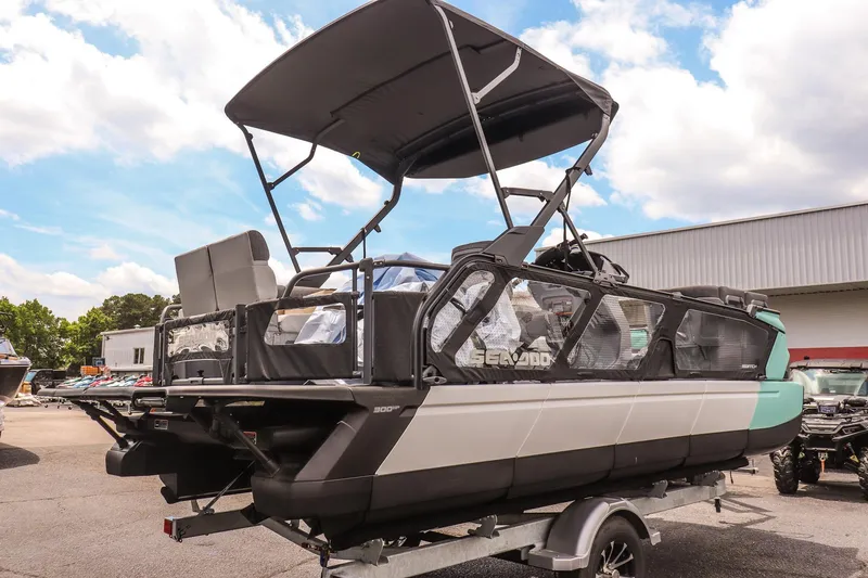 Slide: The Image of 2026 Sea-Doo Switch Cruise 21 pontoon boat with canopy on trailer, outdoor setting. - 3