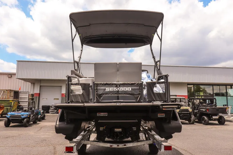 Slide: The Image of 2026 Sea-Doo Switch Cruise 21 pontoon boat parked outdoors, rear view. - 4