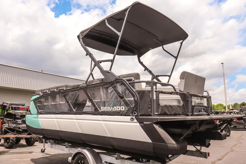 Slide: The Image of 2026 Sea-Doo Switch Cruise 21 pontoon boat with canopy, parked outdoors. - 5