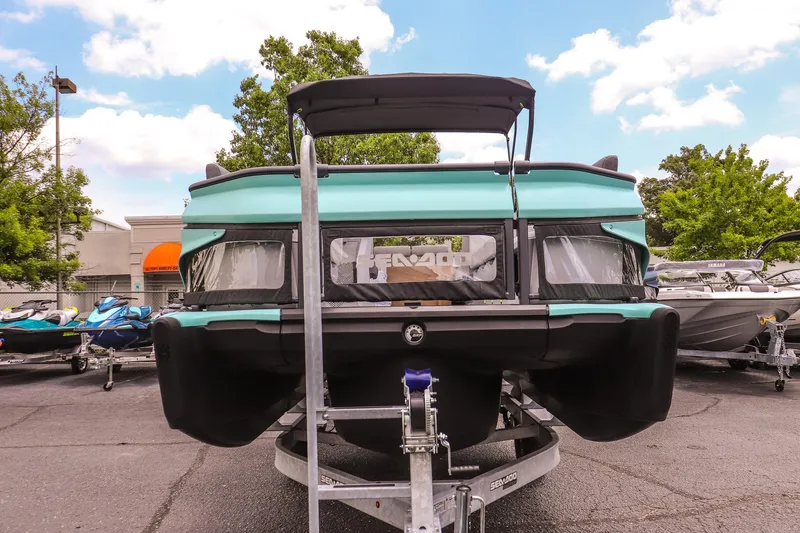 Slide: The Image of 2026 Sea-Doo Switch Cruise 21 pontoon boat on trailer, parked outdoors. - 8