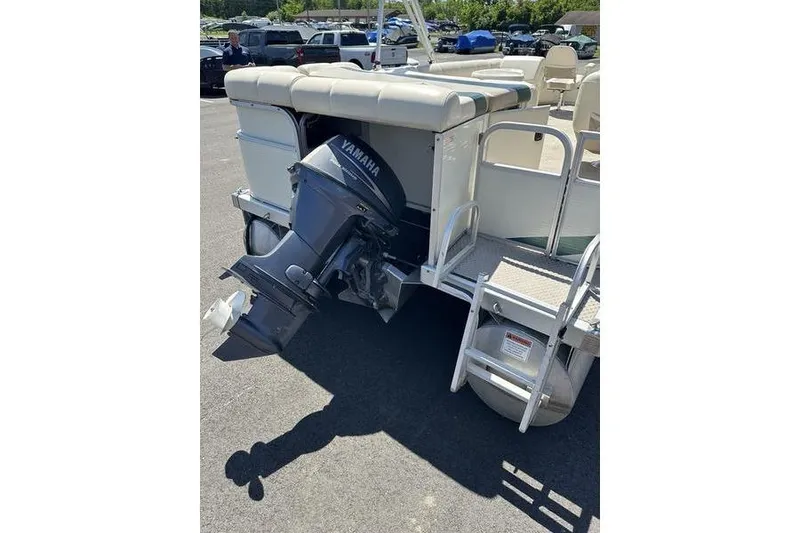 Slide: The Image of 2004 Bennington 2075 FS pontoon boat with Yamaha outboard motor, parked outdoors. - 10