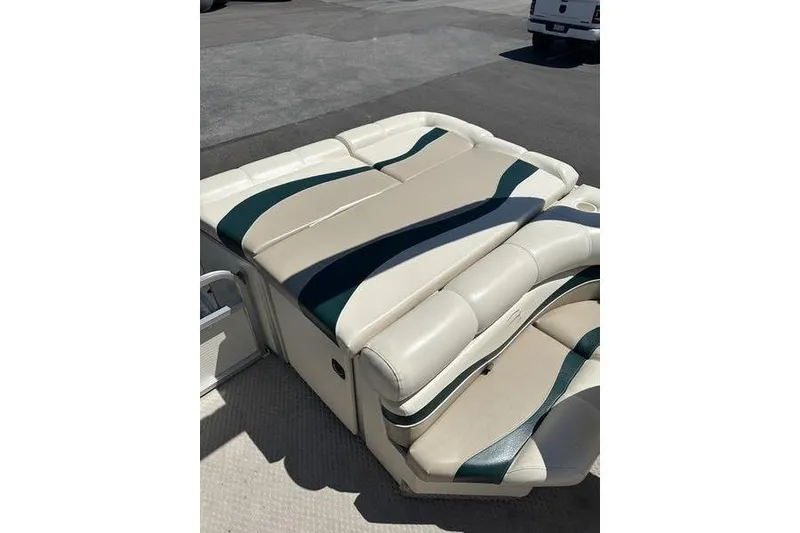 Slide: The Image of 2004 Bennington 2075 FS boat seating with beige and green upholstery. - 11