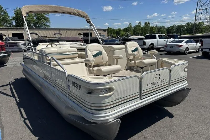 Slide: The Image of 2004 Bennington 2075 FS pontoon boat with canopy, parked in a lot under a clear sky. - 12