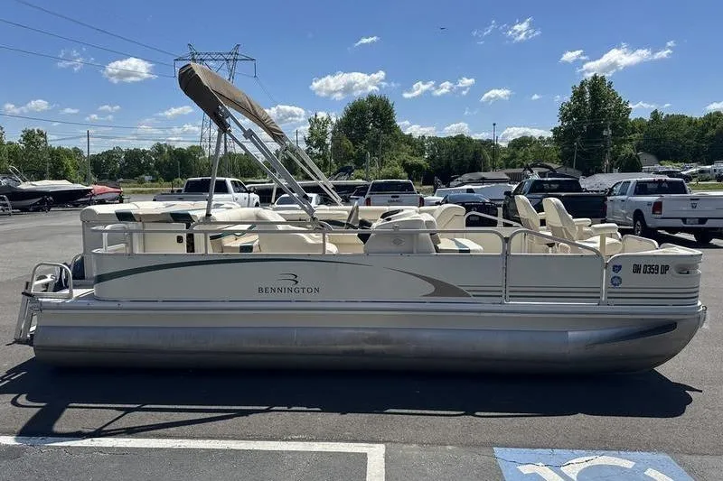 Slide: The Image of 2004 Bennington 2075 FS pontoon boat parked outdoors on a sunny day. - 4