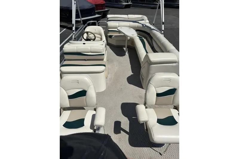 Slide: The Image of 2004 Bennington 2075 FS pontoon boat interior with white seating and steering console. - 5