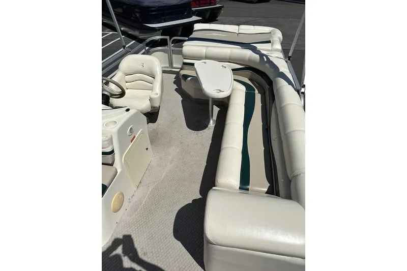 Slide: The Image of 2004 Bennington 2075 FS boat interior with white seating and table. - 6