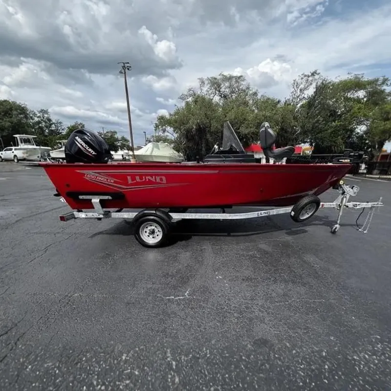 The Image of Red 2026 Lund 1650 Angler SS boat on trailer. - 0