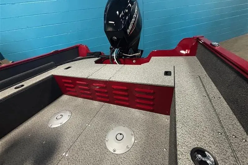 Slide: The Image of 2026 Lund 1650 Angler SS boat interior with Mercury engine, red and gray design. - 6