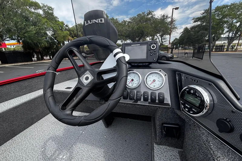 Slide: The Image of 2026 Lund 1650 Angler SS boat dashboard with steering wheel and gauges. - 7