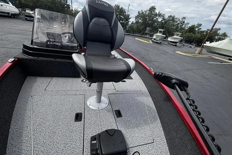 Slide: The Image of 2026 Lund 1650 Angler SS boat interior with swivel seat and control panel. - 9