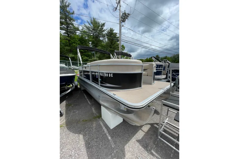 The Image of 2010 Harris FloteBote 200 Cruiser CX pontoon boat parked outdoors. - 1