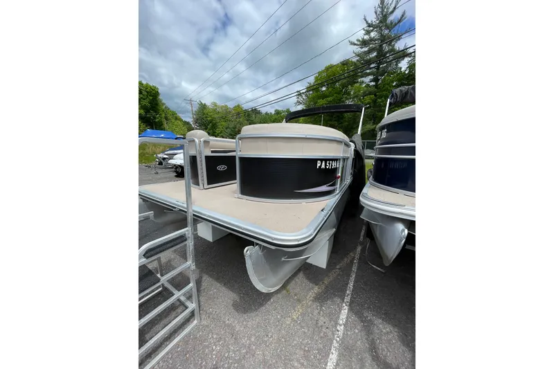 Slide: The Image of 2010 Harris FloteBote 200 Cruiser CX pontoon boat parked outdoors. - 2