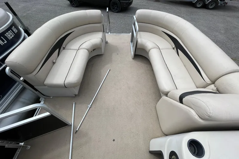 Slide: The Image of 2010 Harris FloteBote 200 Cruiser CX interior with beige seating and open deck layout. - 4