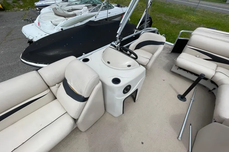 Slide: The Image of Interior view of a 2010 Harris FloteBote 200 Cruiser CX pontoon boat with beige seating. - 9