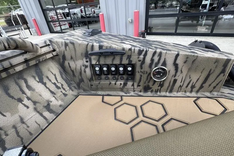 Slide: The Image of Control panel of 2026 Excel 183 Tomahawk boat with camouflage design and hexagonal floor pattern. - 13