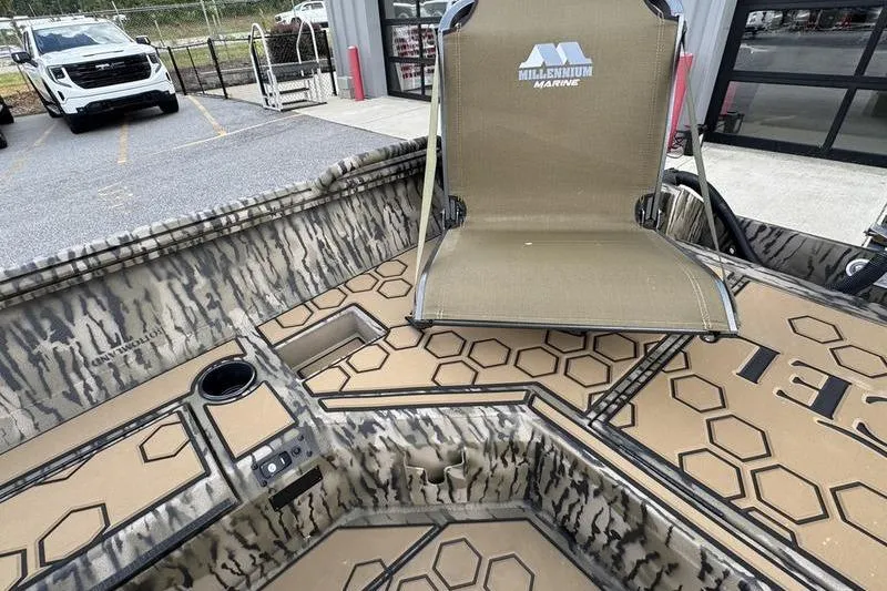 Slide: The Image of 2026 Excel 183 Tomahawk boat interior with Millennium Marine seat and hexagonal pattern design. - 15