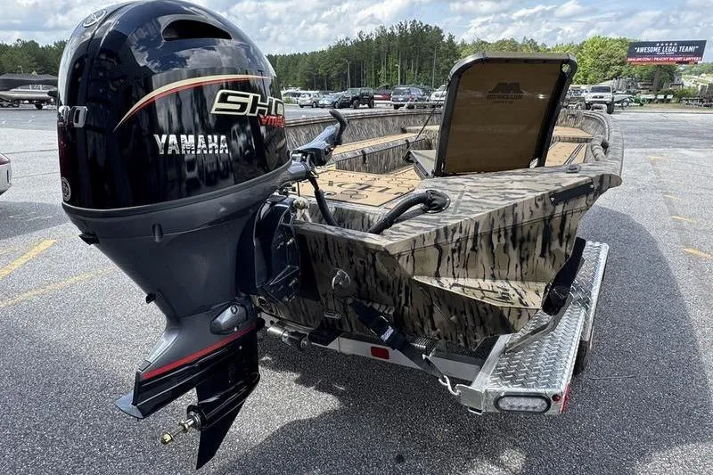 Slide: The Image of 2026 Excel 183 Tomahawk boat with Yamaha motor on trailer in parking lot. - 17