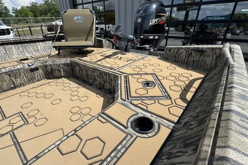 Slide: The Image of 2026 Excel 183 Tomahawk boat interior with hexagonal pattern flooring and Yamaha outboard motor. - 18