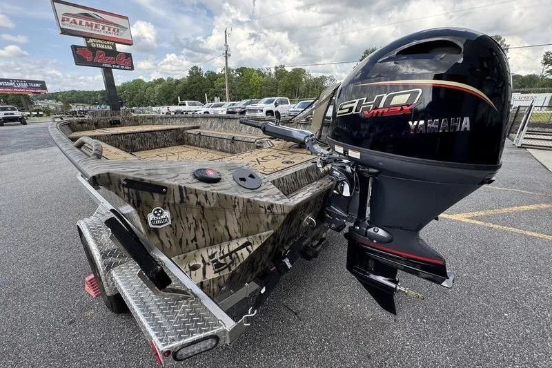 Slide: The Image of 2026 Excel 183 Tomahawk boat with Yamaha SHO engine on a trailer in a parking lot. - 22