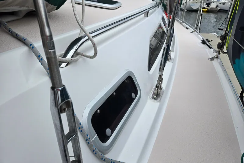 Slide: The Image of Close-up of a 1999 Catalina 380 sailboat deck with rigging and window details. - 12