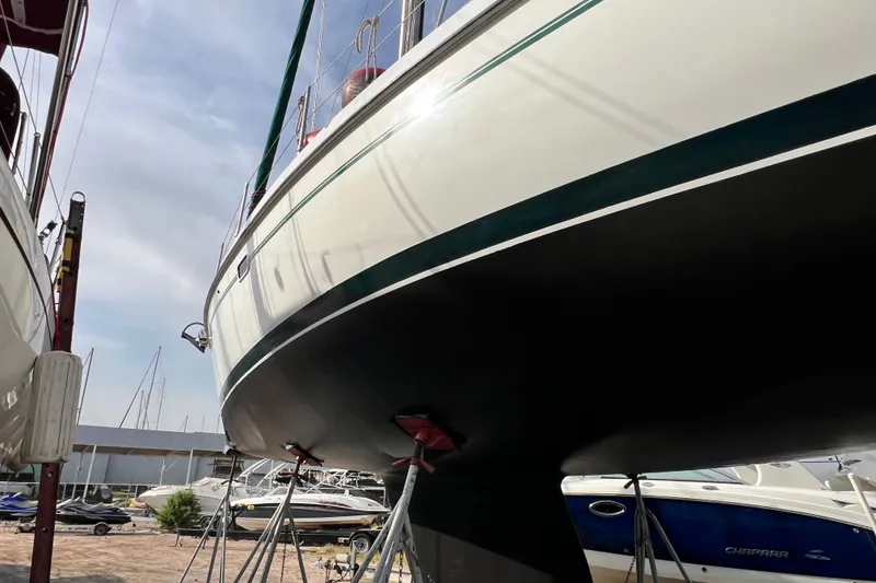 Slide: The Image of 1999 Catalina 380 sailboat on stands, marina background, clear sky. - 15