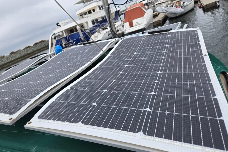 Slide: The Image of Solar panels on a 1999 Catalina 380 sailboat docked at a marina. - 21