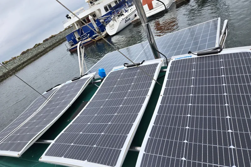 Slide: The Image of Solar panels on a 1999 Catalina 380 sailboat docked at a marina. - 22