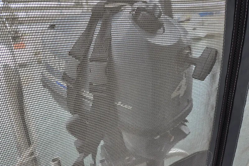Slide: The Image of Outboard motor viewed through mesh on a 1999 Catalina 380 sailboat. - 28