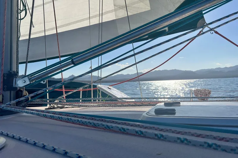 Slide: The Image of Sailing on a 1999 Catalina 380 with sunlit ocean and mountain views. - 3