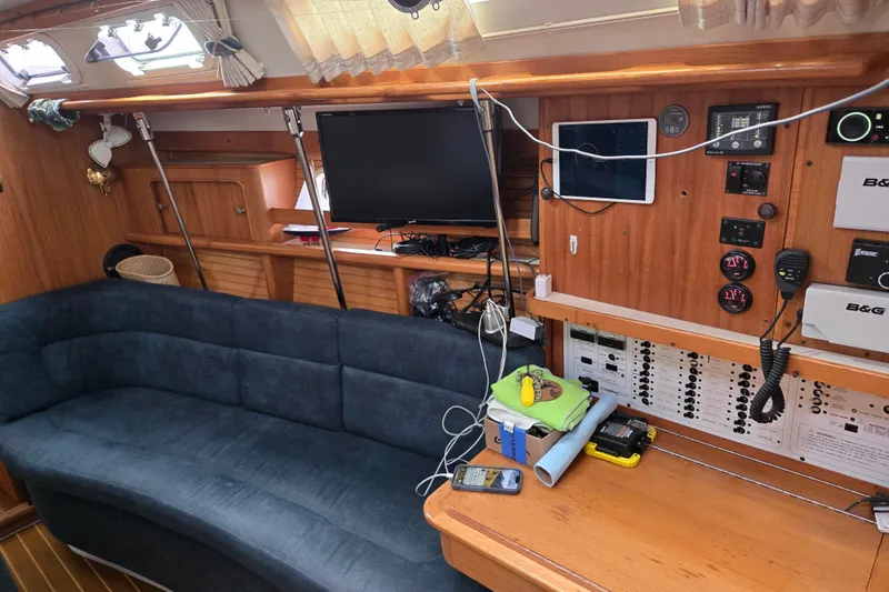 Slide: The Image of Interior of a 1999 Catalina 380 sailboat with navigation equipment and seating area. - 32