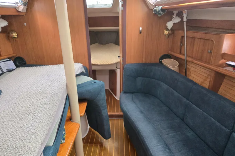 Slide: The Image of Interior of a 1999 Catalina 380 sailboat with cozy seating and wooden finishes. - 33