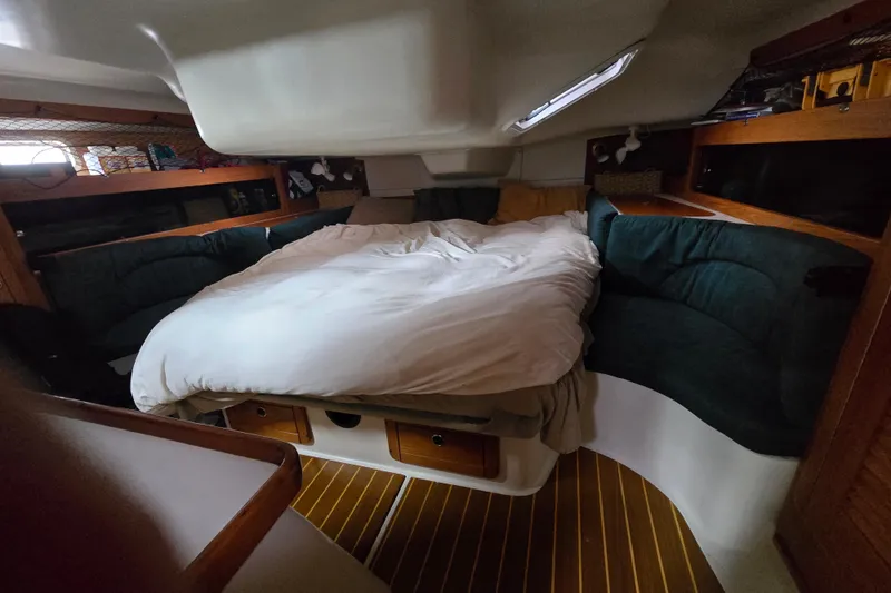 Slide: The Image of Cozy cabin interior of a 1999 Catalina 380 sailboat with a comfortable bed. - 36