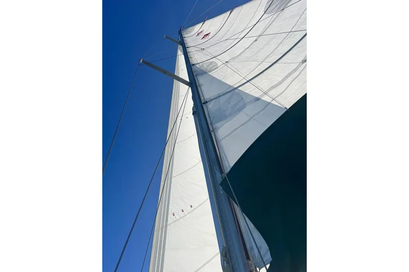 Slide: The Image of Sails of a 1999 Catalina 380 yacht against a clear blue sky. - 4
